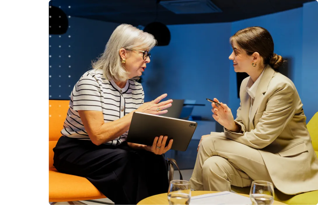 Two people sitting face to face in a discussion. 